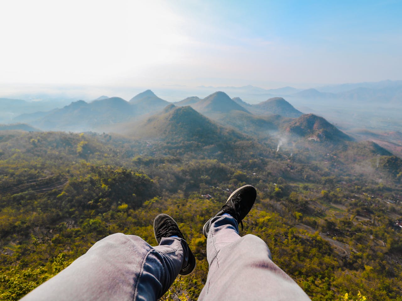 services-03 Feet dangling over the stunning landscape of Wonogiri Hills during sunrise, capturing the essence of Indonesian nature.